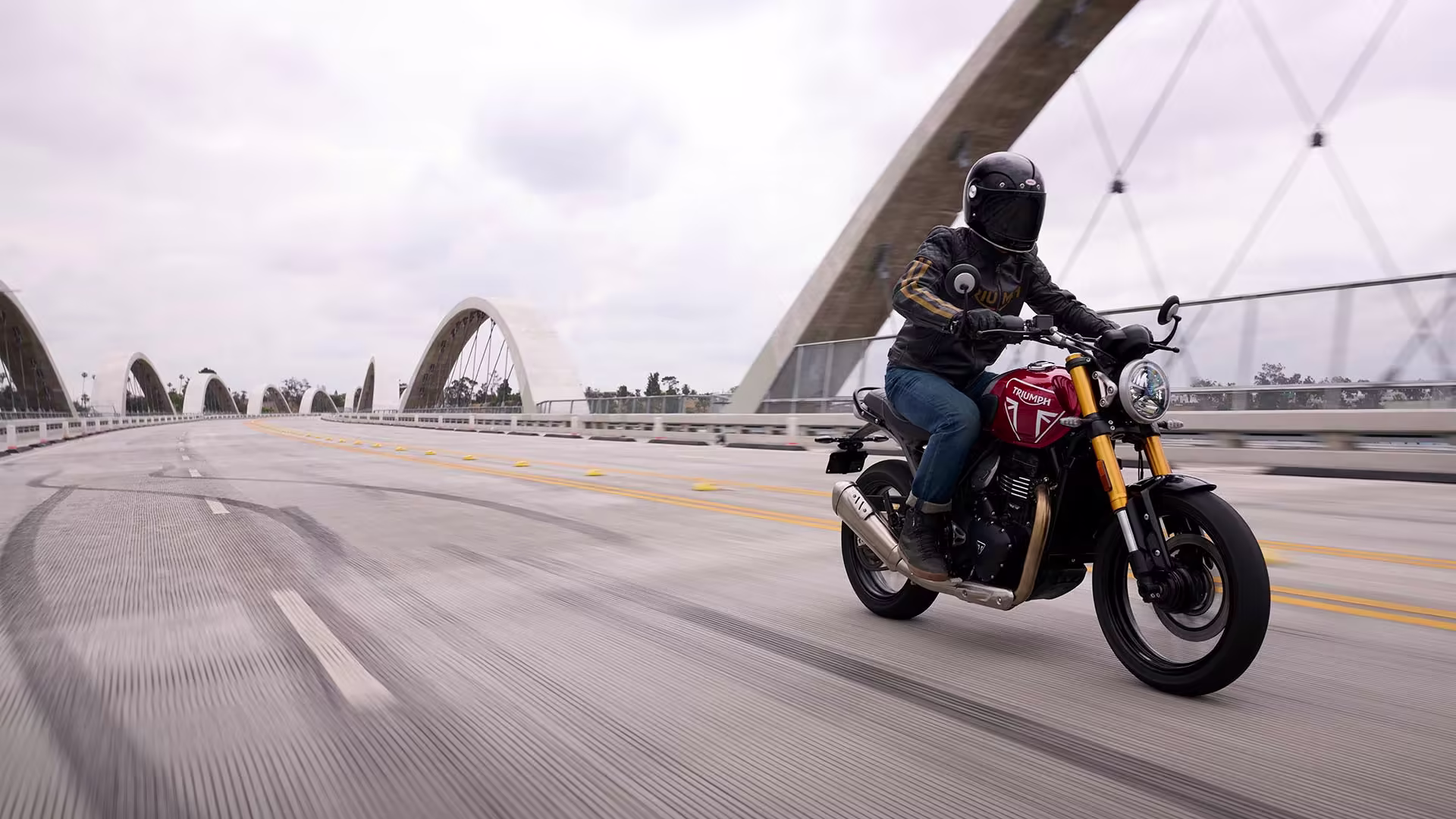 2025 Triumph Speed 400 being driven on a bridge In New Orleans, LA